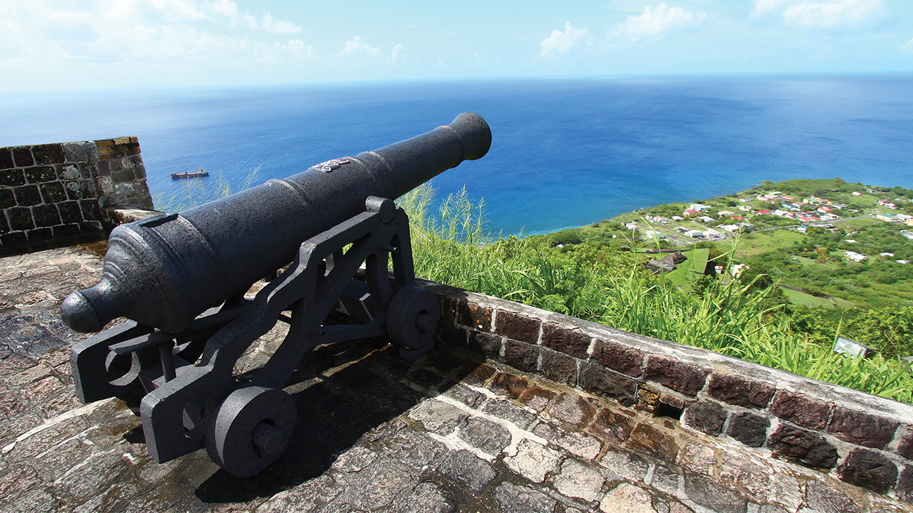 Canon looking out over a wall at Brimstone Hill Fortress, Saint Kitts, a Marriott Vacation Club timeshare destination