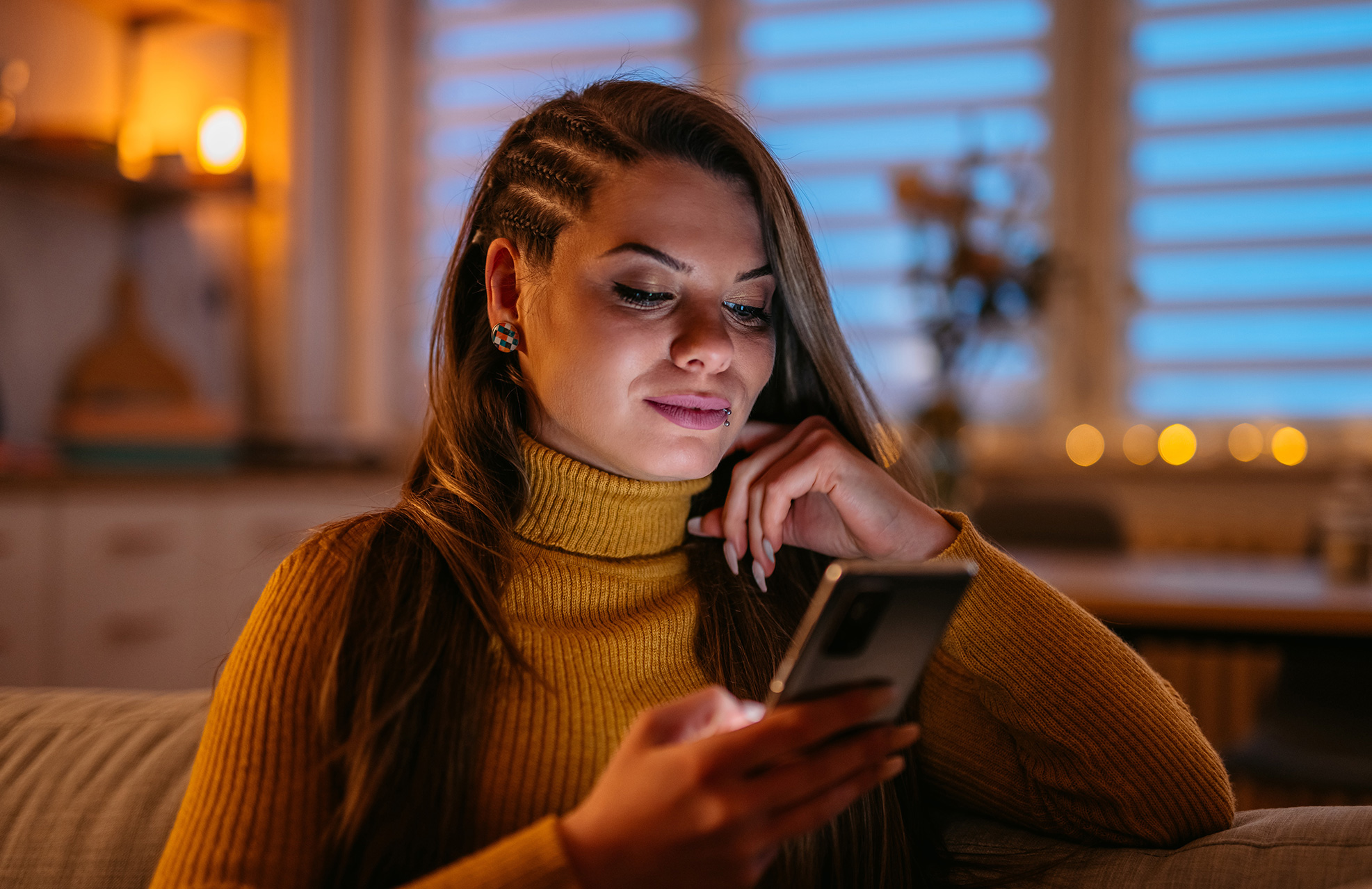 Woman looking at phone in her home