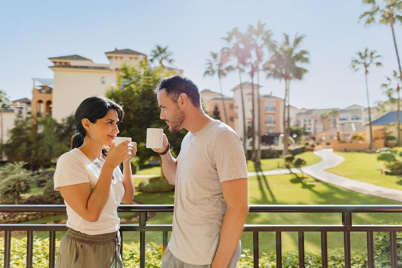 Couple having coffee on a balcony at a vacation club resort