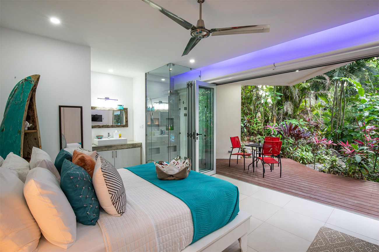 An ultra-modern bedroom looks out on the jungle outside