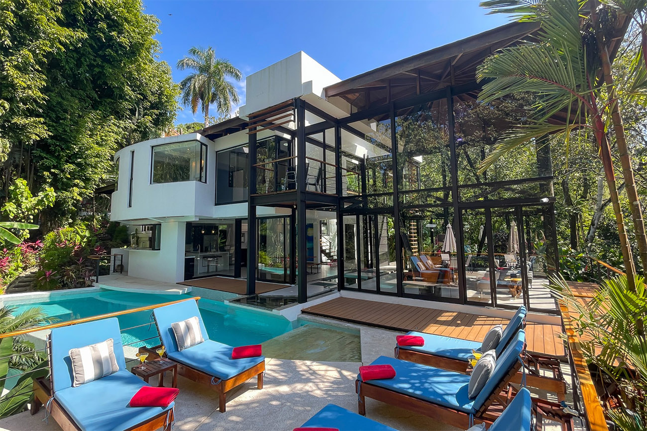 A sparkling pool sits in front of a unique home