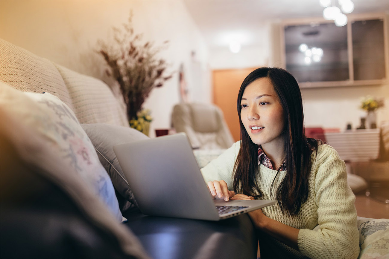 Woman on laptop in her living area