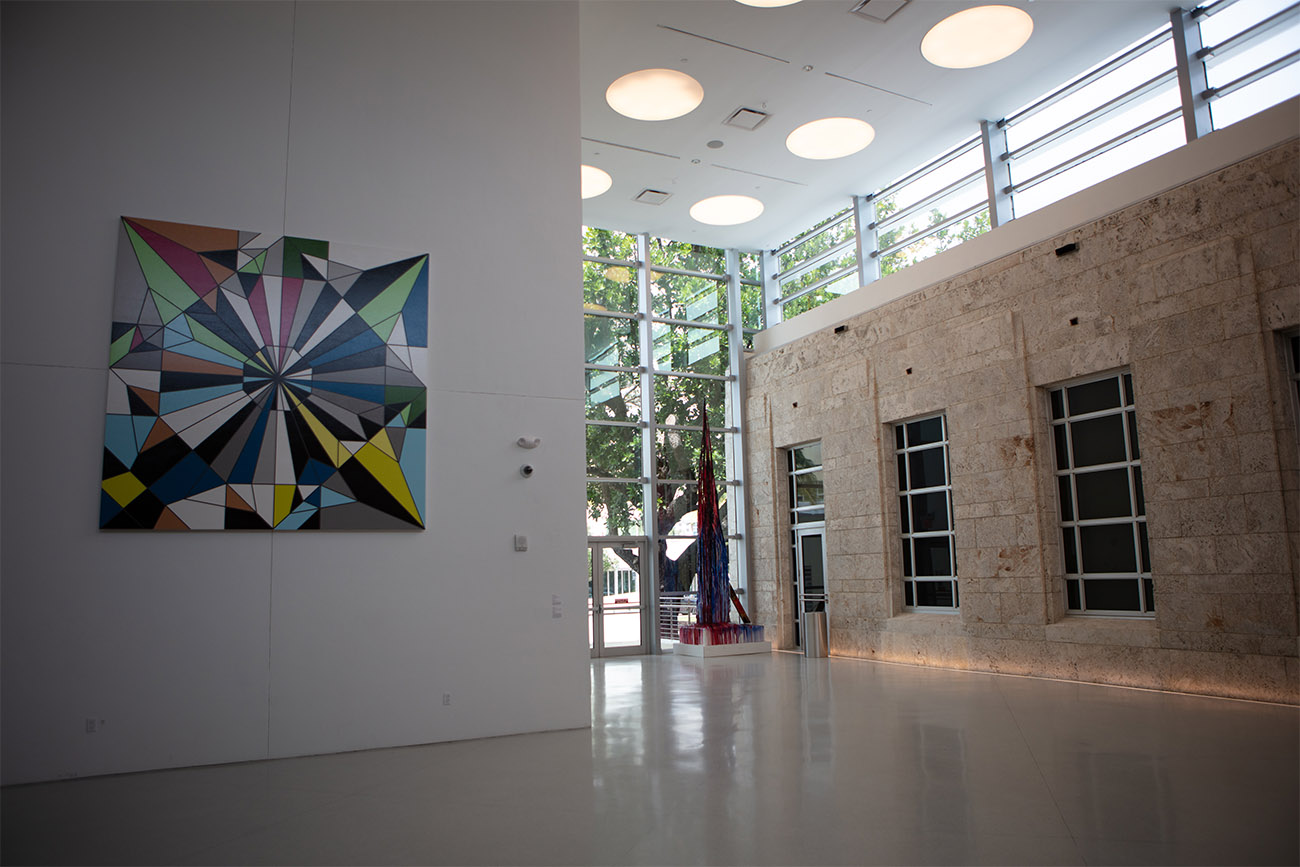 A multicolored art piece hangs on the walls of a museum on Miami Beach.