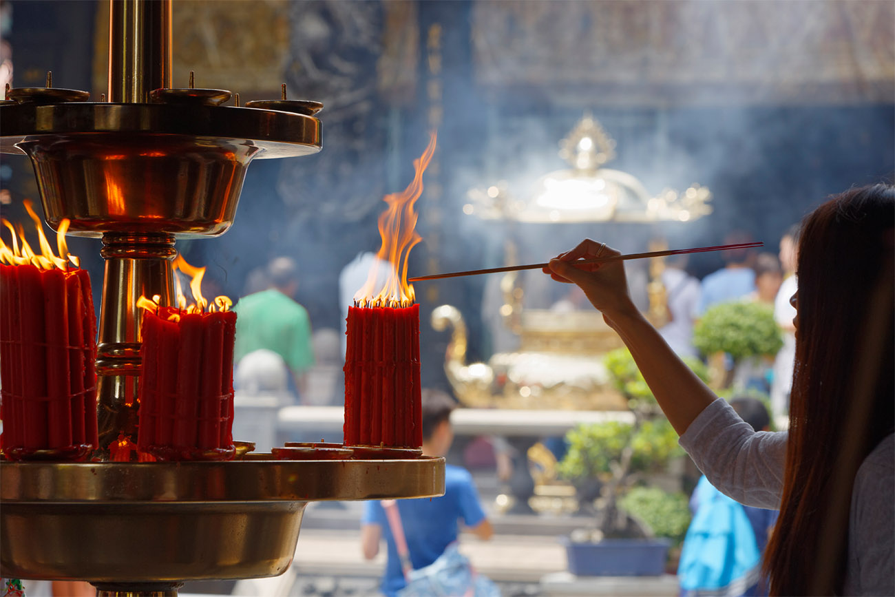Ceremonial candles are lit surrounding a golden altar