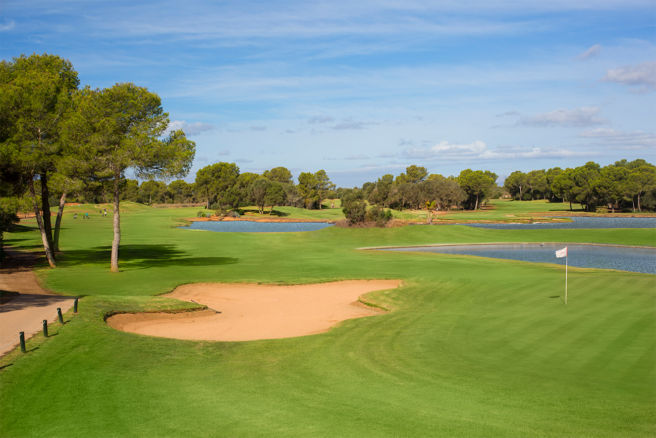 A sprawling golf course sits under a clear sky