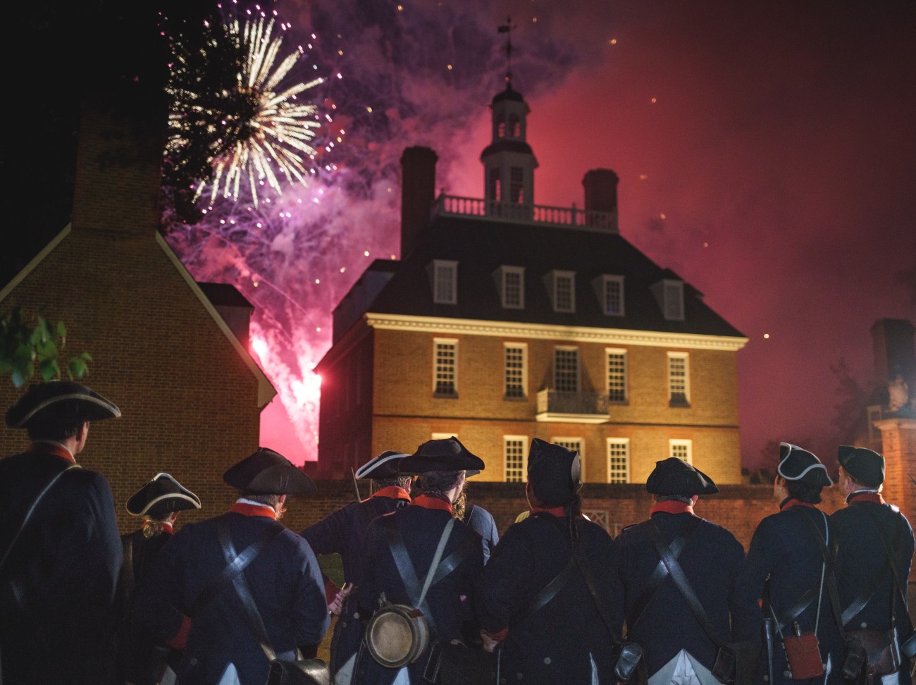 Fireworks burst in Colonial Williamsburg on July 4th.
