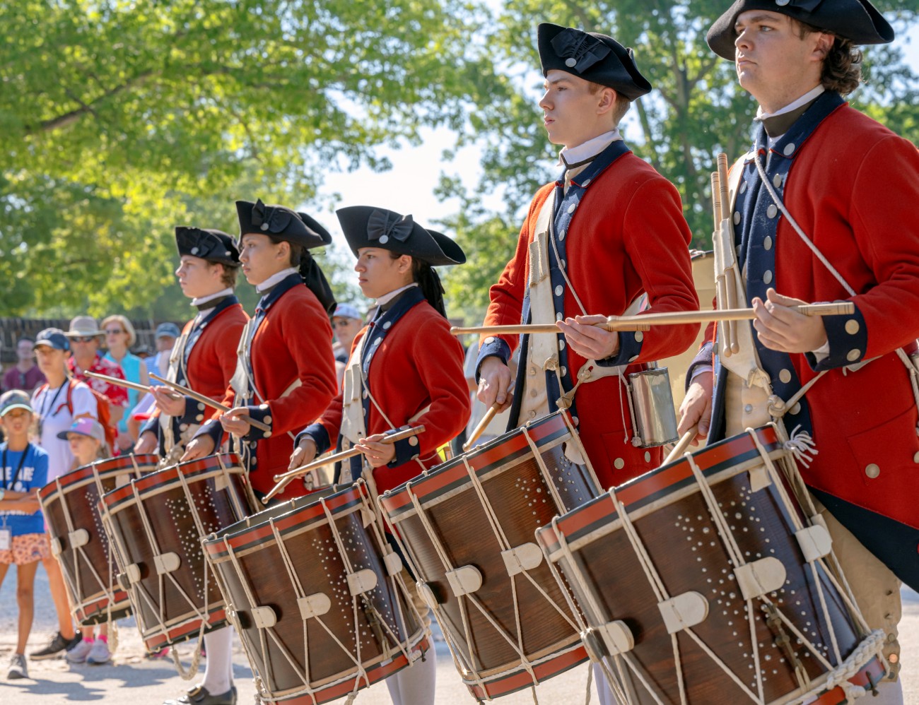 2) Marching performers in Colonial uniforms play drums for Independence Day.