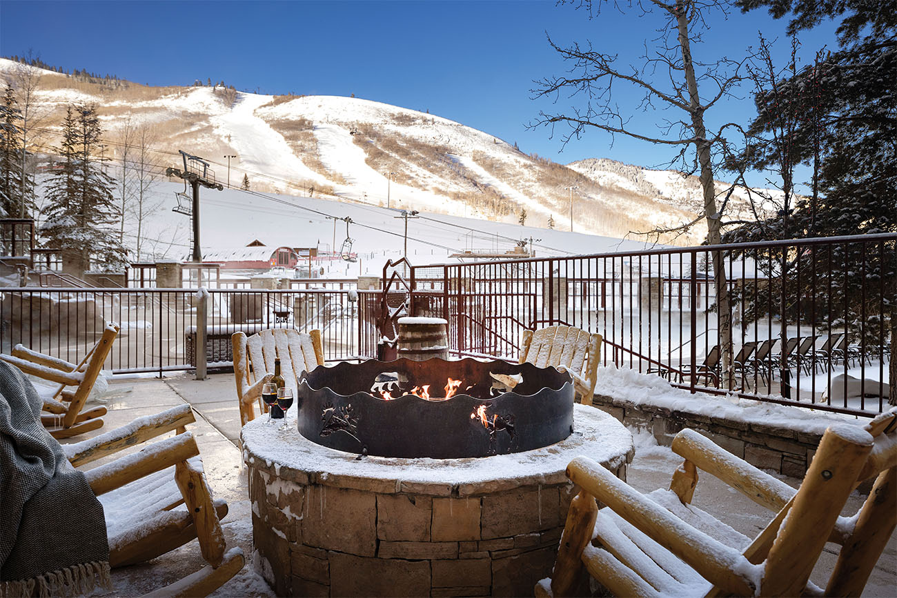 A crackling firepit warms the surrounding chairs in Utah.