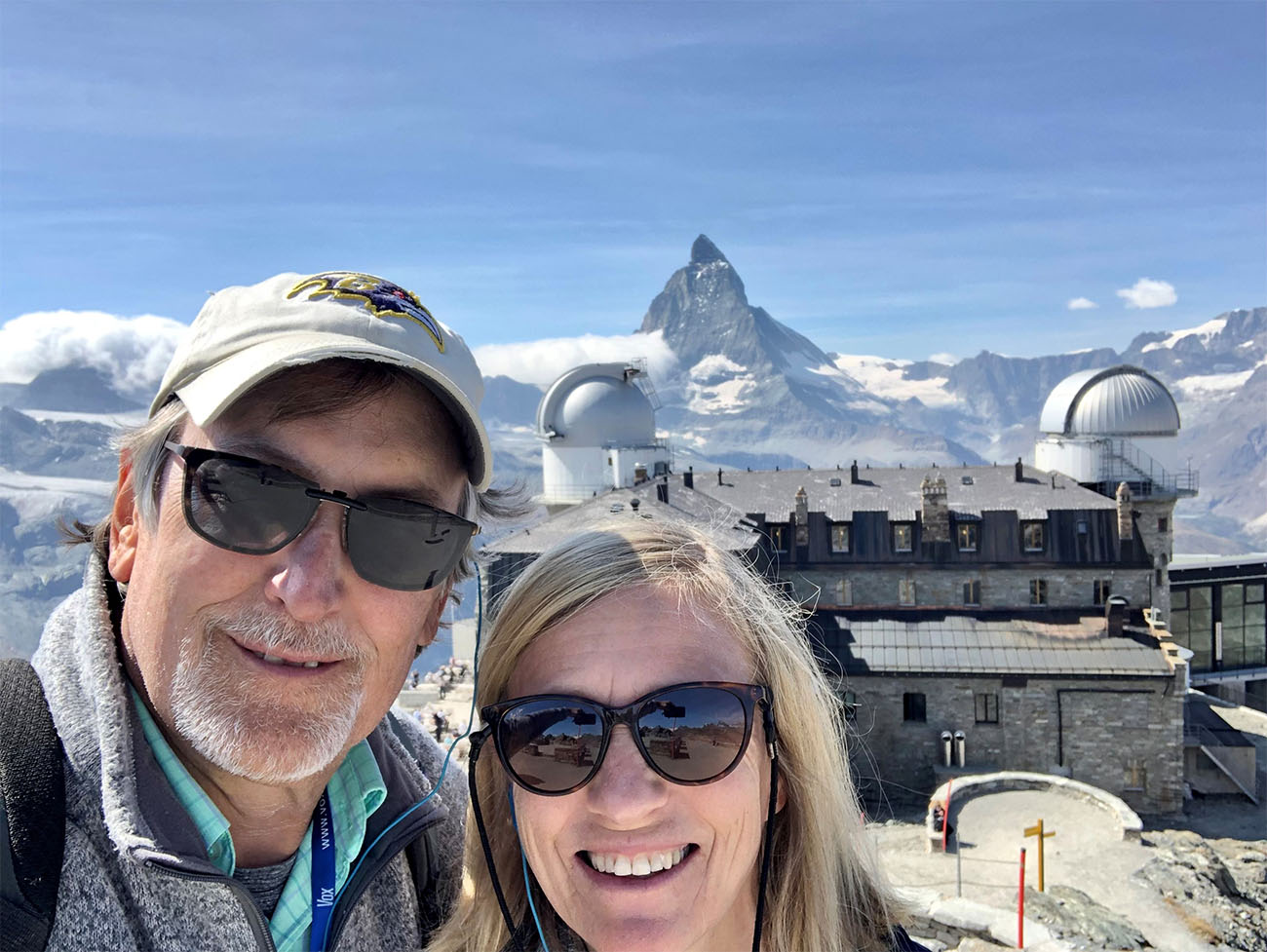 A man and a woman pose in front of the Matterhorn mountain