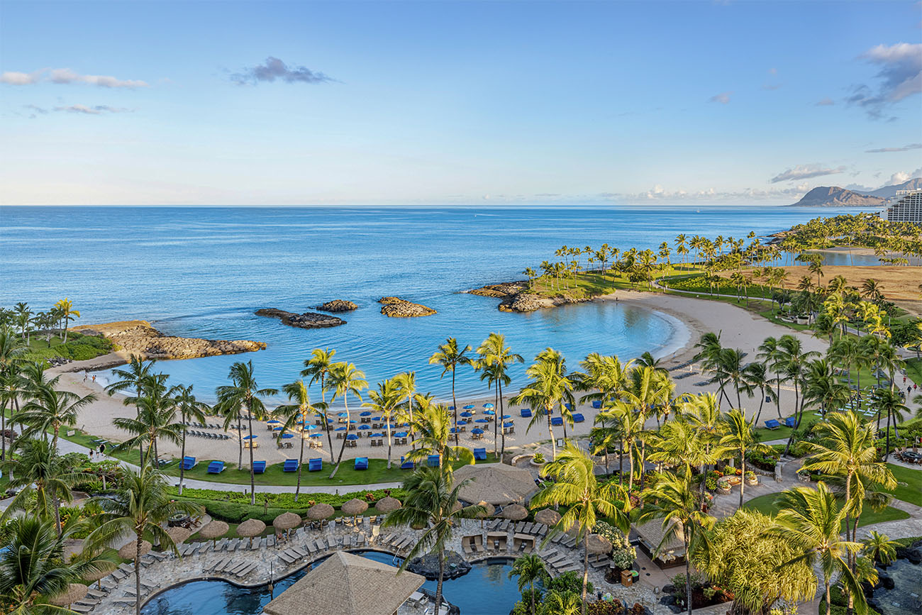 A sparkling cove glistens under a clear Hawaiian sky.