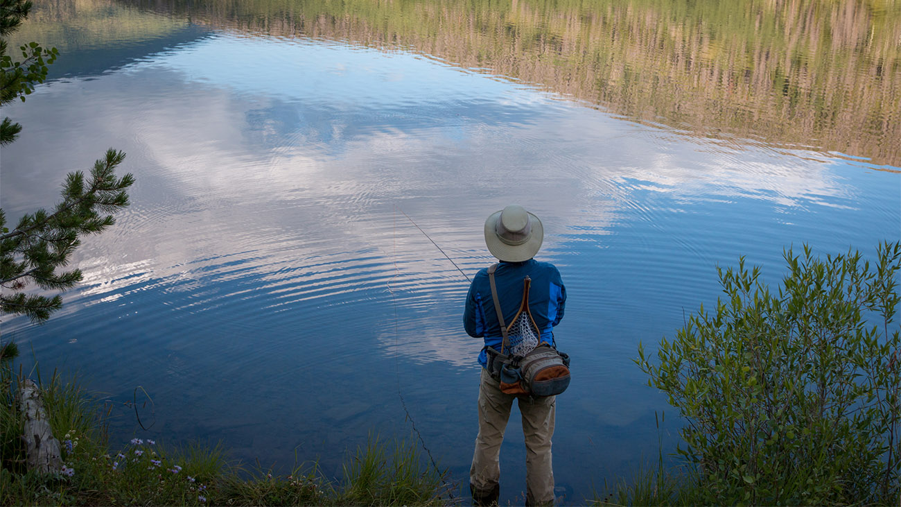 Man fly fishing in a river in Steamboat Springs, Colorado