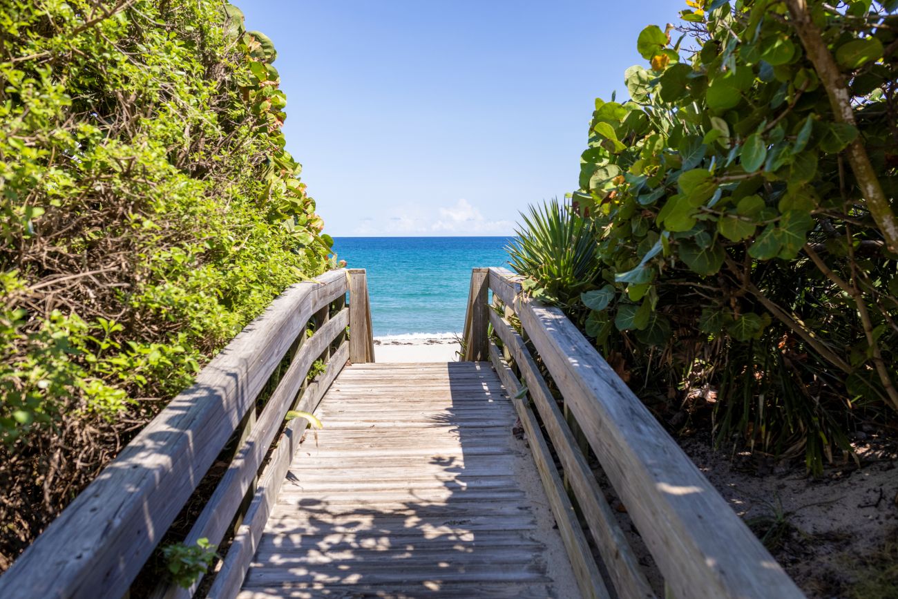 A boardwalk leads to a beach shoreline.