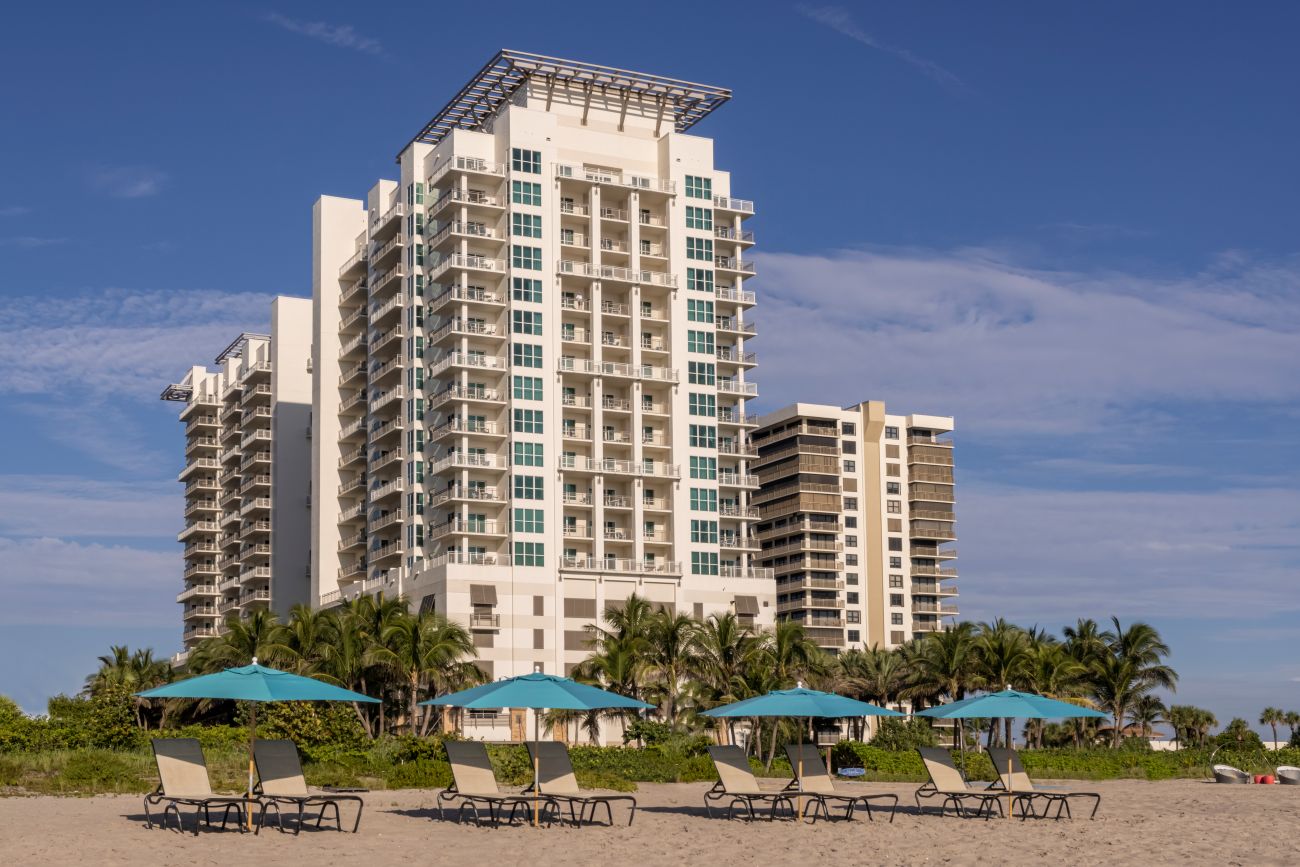 Beach lounge chairs in front of Marriott’s Oceana Palms.