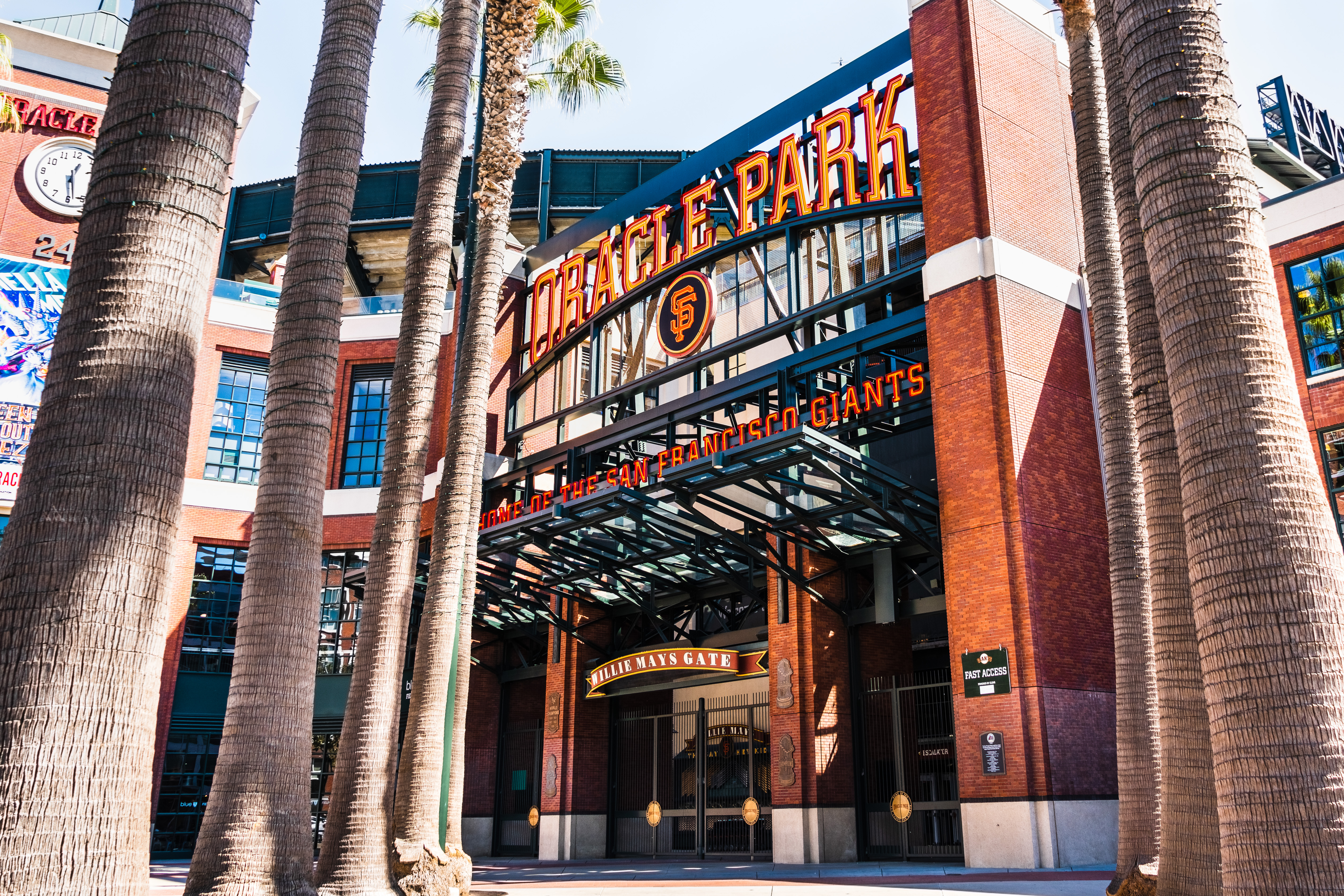 The sun shines on the entrance gate to a baseball stadium before the crowds show.