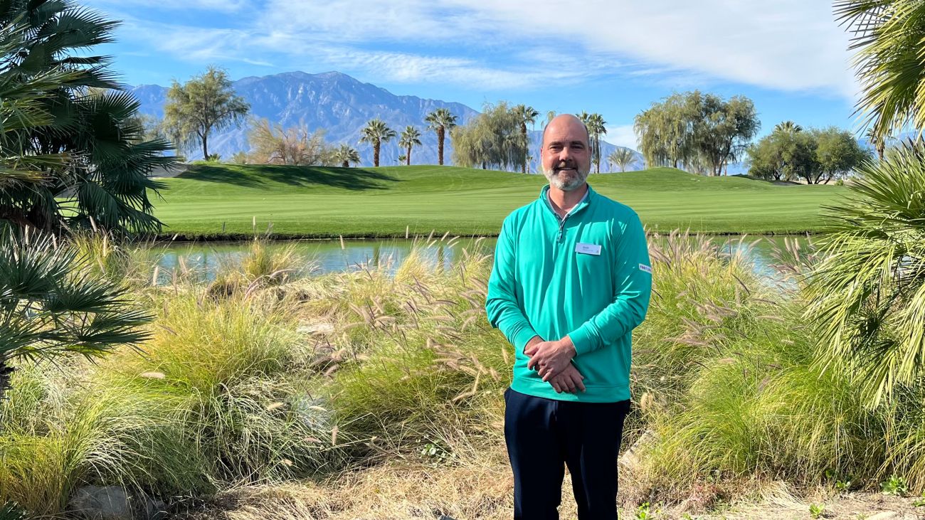 The bright greens of a golf course are lit by the sun in front of Marriott’s Shadow Ridge resort.