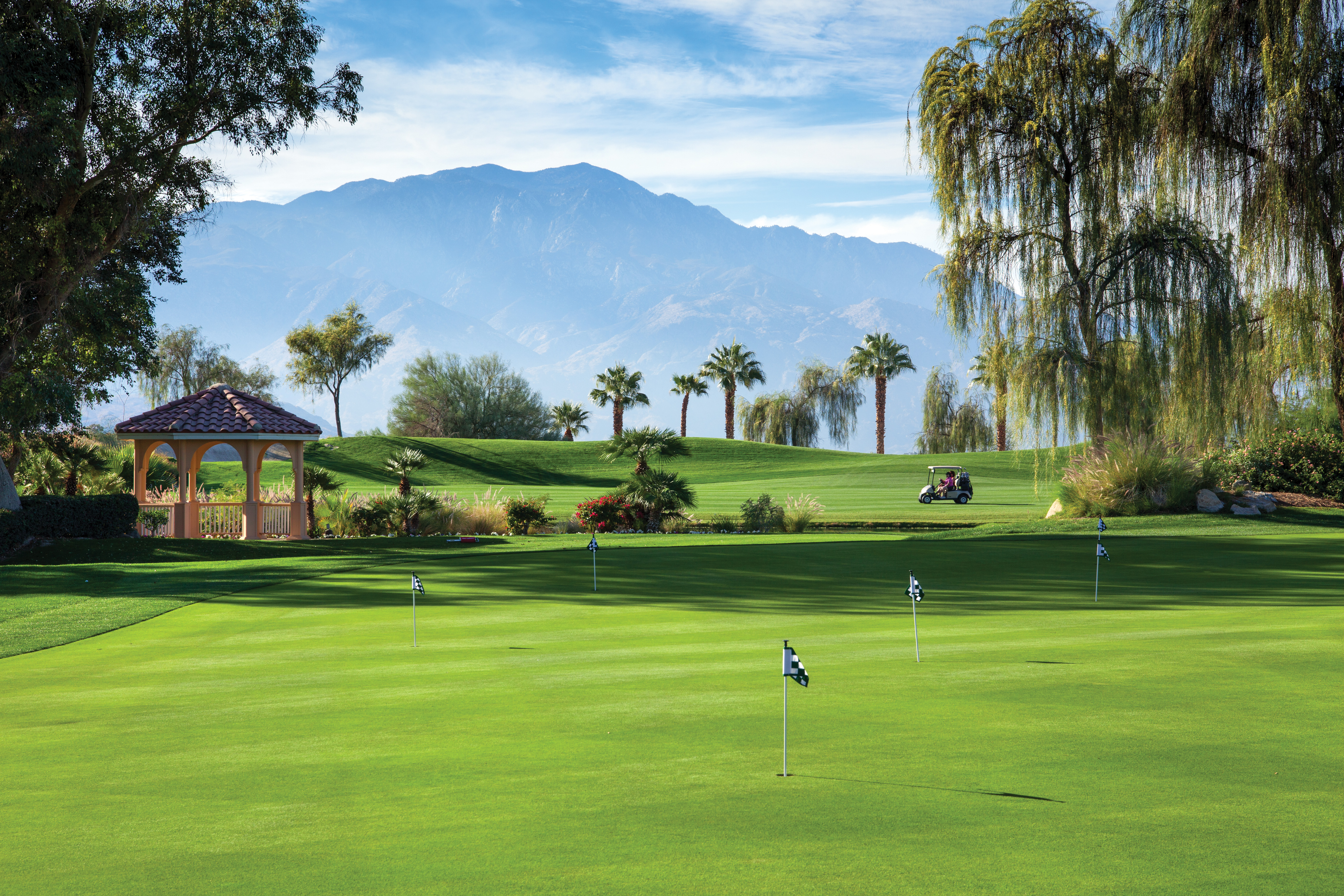 The bright greens of a golf course are lit by the sun in front of Marriott’s Shadow Ridge resort.