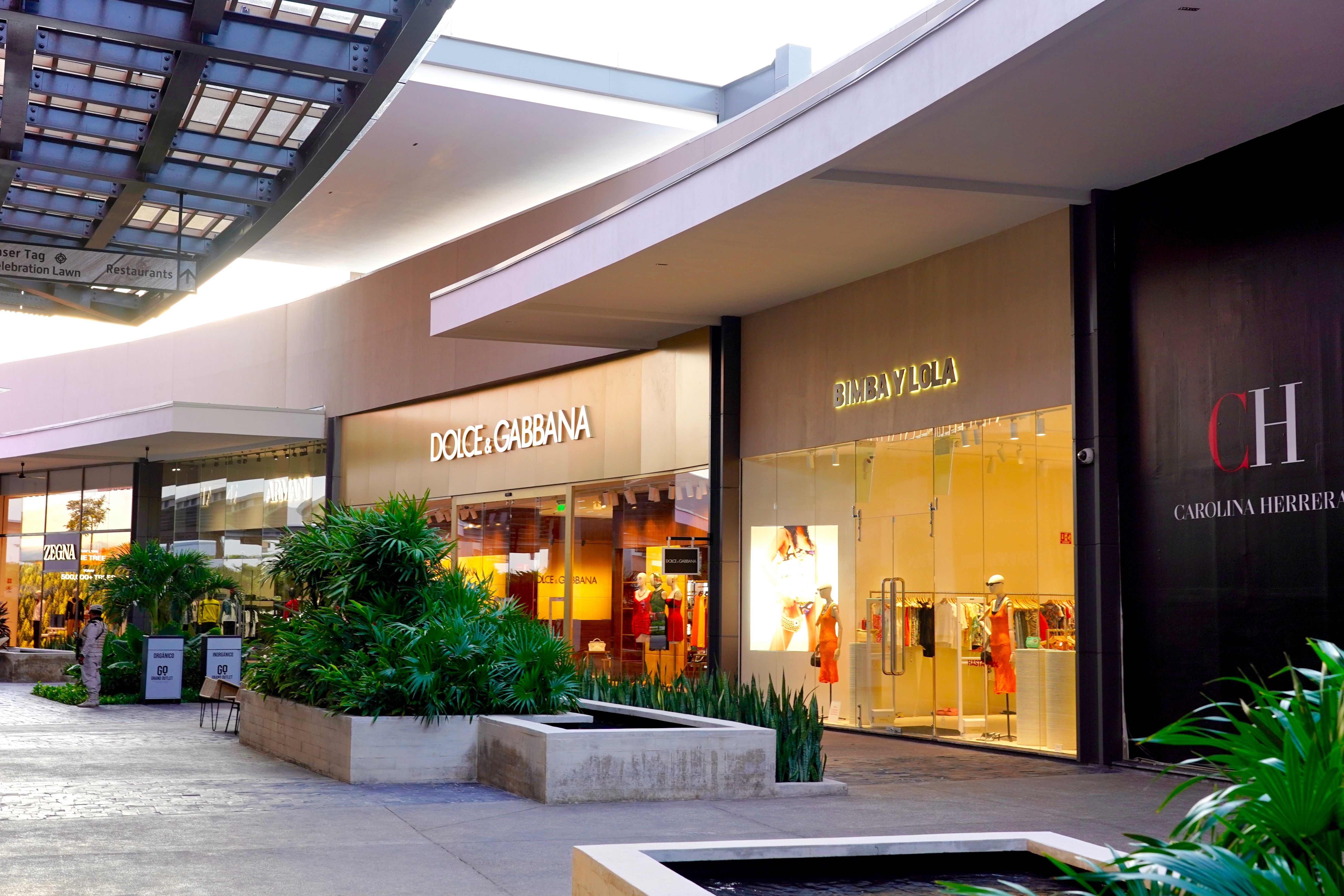 A variety of stores in a shopping mall sit ready to open for the day.