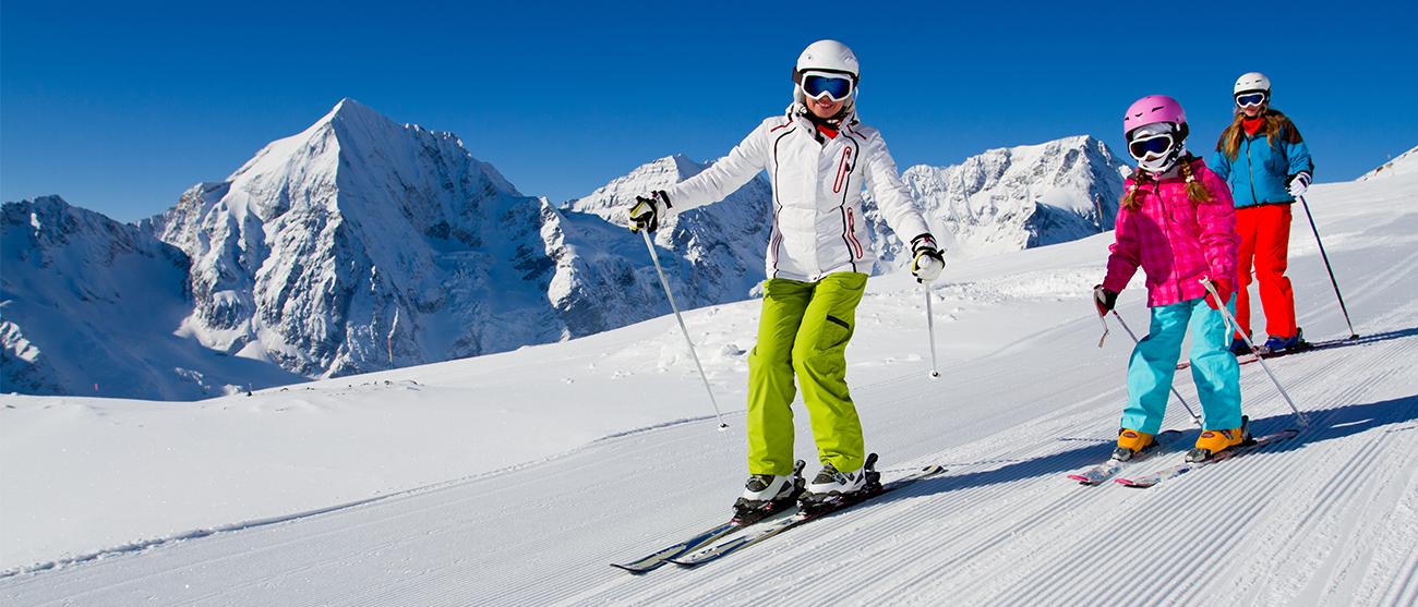 The Hendersons, a family of 3 timeshare owners skiing down a mountain at a Marriott Vacation Club destination