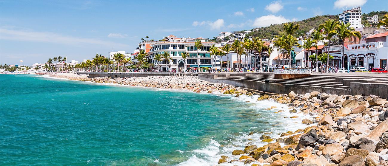 Terraced seawall leading to waves breaking on rocks in Puerto Vallarta, Mexico