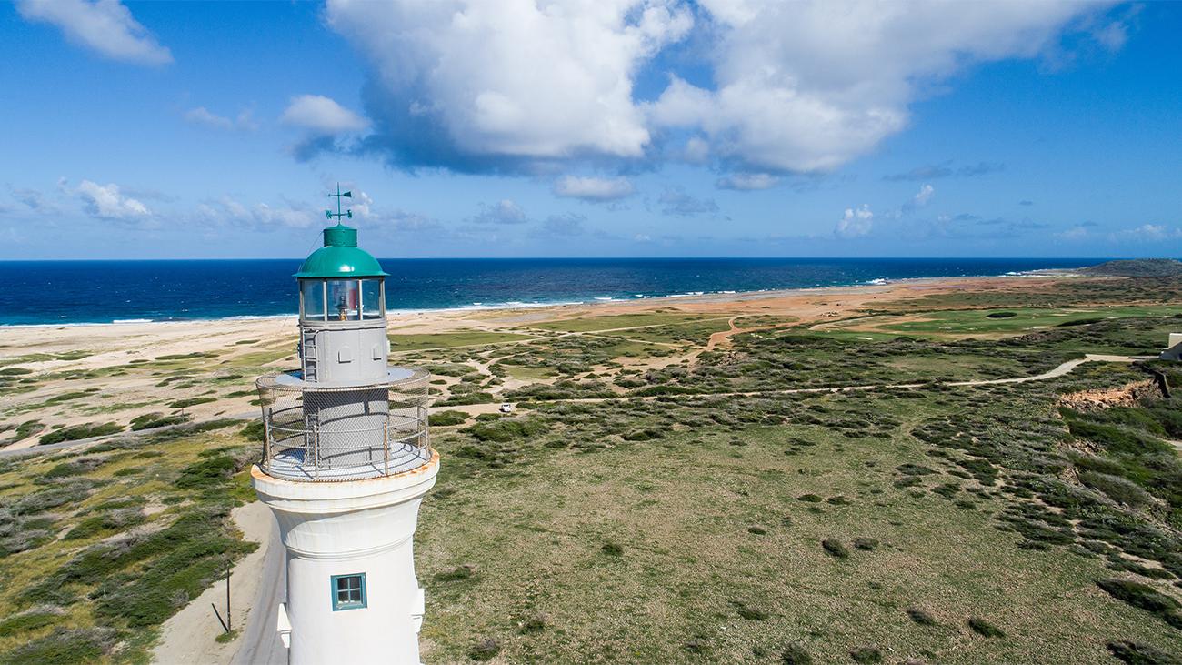 Lighthouse overlooking ocean coastline of Aruba, a Marriott Vacation Club destination