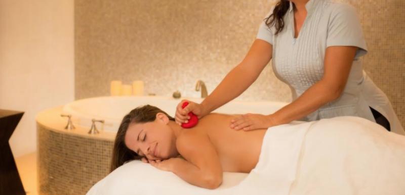 Smiling woman receiving a back massage at Marriott Vacation Club Spa Helani, Maui