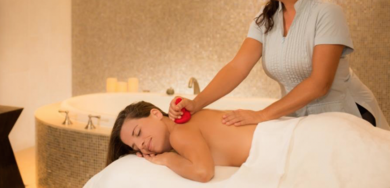 Smiling woman receiving a back massage at Marriott Vacation Club Spa Helani, Maui