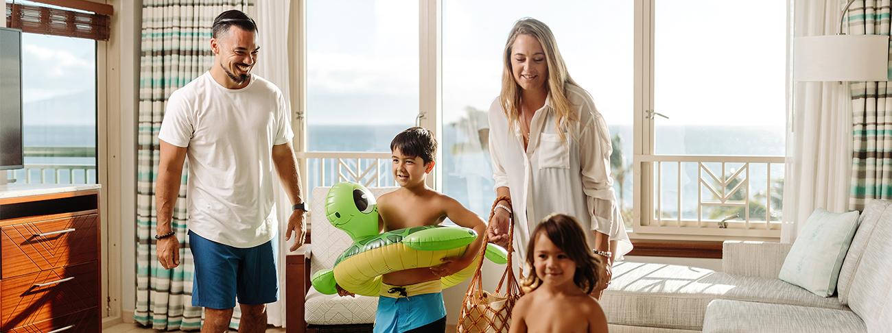 Family with young children, girl tossing salad in timeshare kitchen in Spain